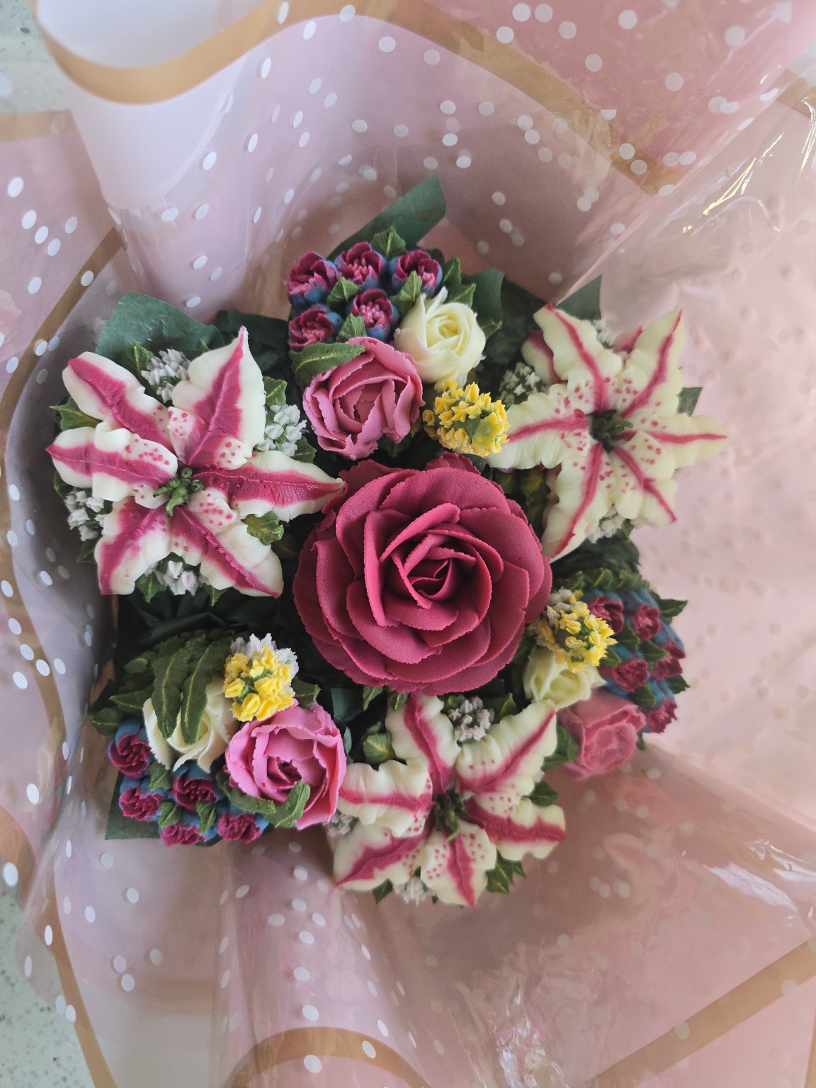 Close view of pink, burgundy and ivory buttercream florals