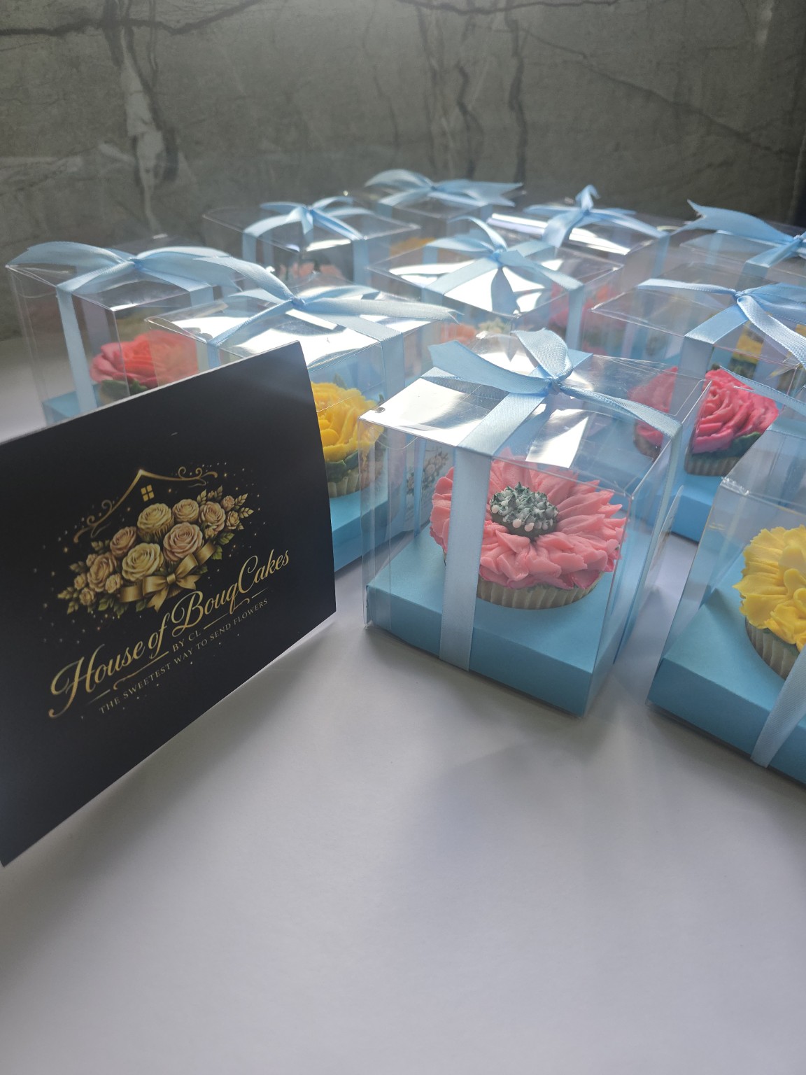 House of BouqCakes floral cupcakes individually presented in blue gift boxes